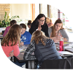 Woman teaching youth about pollinators in a classroom setting.